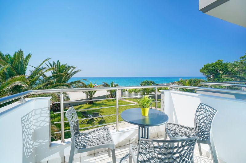 Balcony with palms and the Aegean
