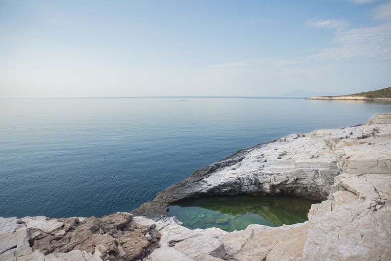 Giola natural rock lagoon with the open sea behind